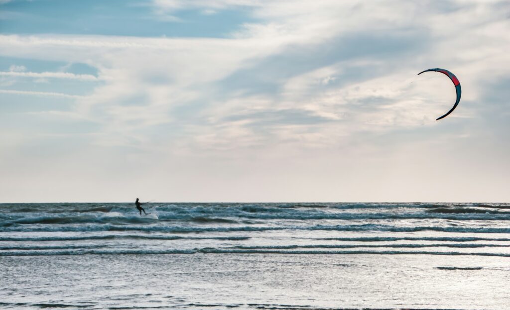 Image of Kitesurfing at Paje Beach during Kaskazi season:
"Kitesurfer riding the steady northeasterly winds at Paje Beach during the Kaskazi season in Zanzibar."

Image of Nungwi Beach during Kuzi season:
"Advanced kitesurfer tackling strong southeast winds at Nungwi Beach during the Kuzi season in Zanzibar."

Image of Paje Beach on a calm day during the shoulder season:
"Kitesurfers enjoying a quiet day at Paje Beach during the shoulder season with light winds."

Image of a sunset kitesurfing session:
"Kitesurfer gliding across the water during a stunning sunset on a calm day in Zanzibar."