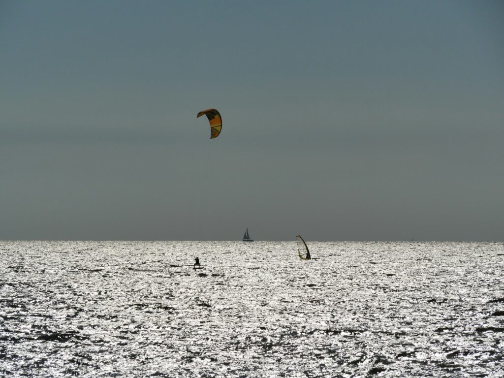 Image of Kitesurfing at Paje Beach during Kaskazi season:
"Kitesurfer riding the steady northeasterly winds at Paje Beach during the Kaskazi season in Zanzibar."

Image of Nungwi Beach during Kuzi season:
"Advanced kitesurfer tackling strong southeast winds at Nungwi Beach during the Kuzi season in Zanzibar."

Image of Paje Beach on a calm day during the shoulder season:
"Kitesurfers enjoying a quiet day at Paje Beach during the shoulder season with light winds."

Image of a sunset kitesurfing session:
"Kitesurfer gliding across the water during a stunning sunset on a calm day in Zanzibar."