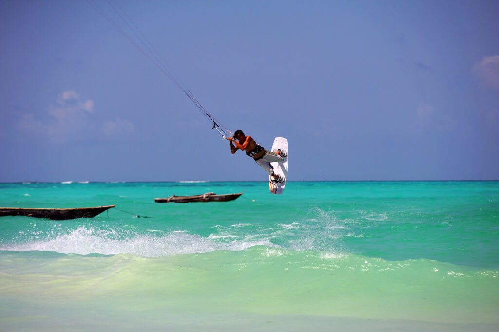 Kitesurfer preparing their kite and board on the sandy shores of Zanzibar, ready for an advanced kitesurfing session.
Close-up of advanced kitesurfing equipment, including a kite, board, and safety gear, on the beach in Zanzibar.